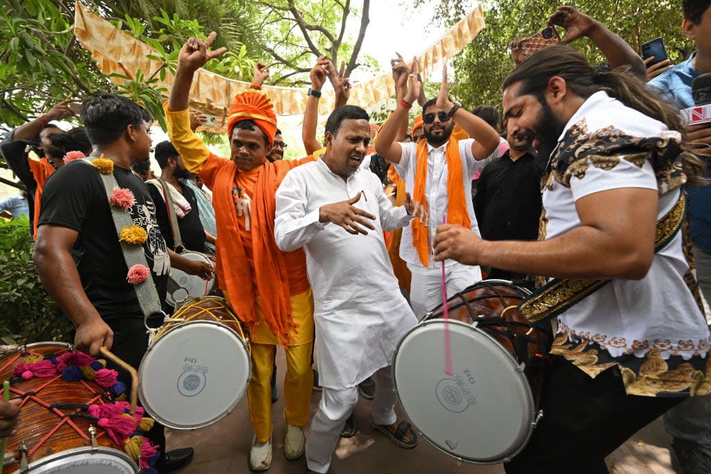 Supporters of the Bharatiya Janata Party outside party headquarters in New Delhi on Tuesday. Prime Minister Narendra Modi was assured a third term but did not win an expected outright majority.  (Money Sharma/AFP/Getty Images - image credit)