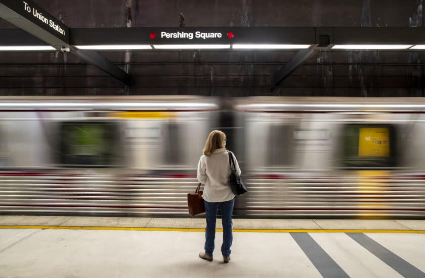 LOS ANGELES, CA - November 16 2021: A commuter waits at Pershing Square station for a Metro Red Line train on Tuesday, Nov. 16, 2021 in Los Angeles, CA. (Brian van der Brug / Los Angeles Times
