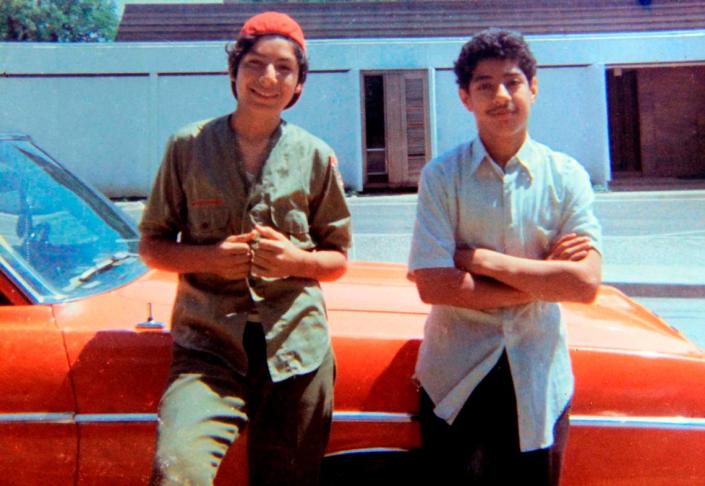 David Rodriguez, 13, left, and his brother Santos Rodriguez, 12, stand by a relative's car in 1973, just a month before Santos died.  (Courtesy of family photo) Courtesy of the Rodriguez family