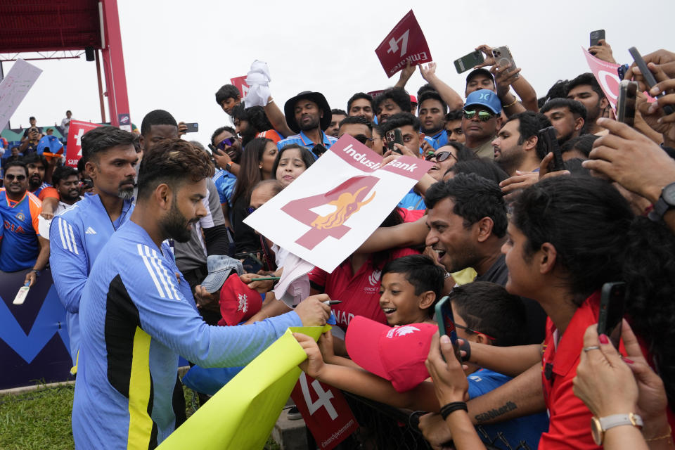 India's Rishabh Pant, second left, sign autographs before the ICC Men's T20 World Cup cricket match between Canada and India was called off due to wet outfield at the Central Broward Regional Park Stadium, Lauderhill, Fla., Saturday, June 15, 2024. (AP Photo/Lynne Sladky)