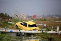 Paramilitary policemen walk at a damaged village after a tornado hit Funing on Thursday, in Yancheng, Jiangsu province, June 25, 2016. REUTERS/Aly Song