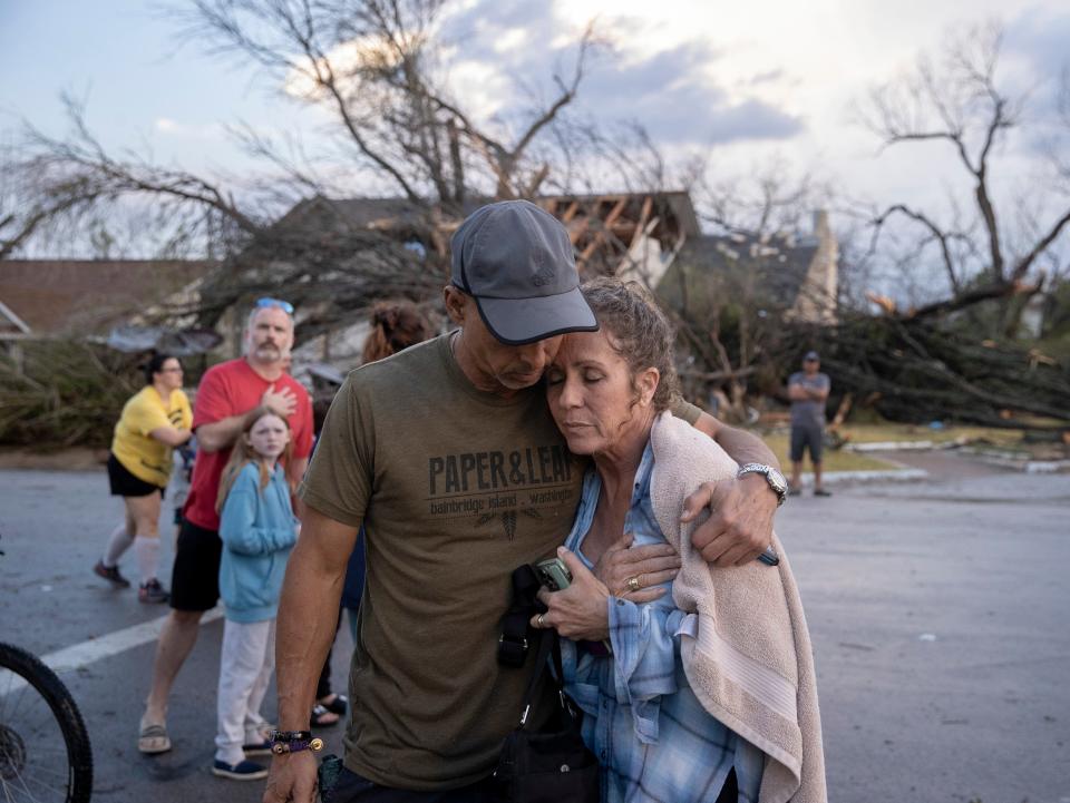 Michael Talamantez comforts his girlfriend Derry Schroer after Talamantez' house on Stratford Drive in Round Rock (AP)