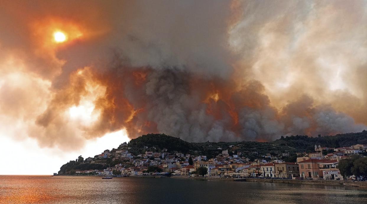 <span class="caption">Wildfires burn on the island of Evia, north of Athens, Greece, on Aug. 3, 2021, as the country dealt with the worst heat wave in decades. Temperatures reached 41 C in parts of Athens. </span> <span class="attribution"><span class="source">(AP Photo/Michael Pappas) </span></span>