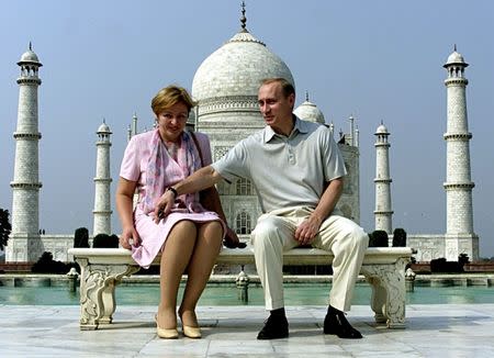 FILE PHOTO: Russian President Vladimir Putin and his wife Lyudmila sit in front of the Taj Mahal while touring city of Agra, India October 4, 2000. REUTERS/Pawel Kopczynski/File Photo