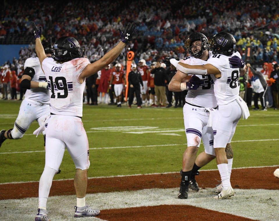 Northwestern offensive lineman Trey Klock (39), center, is congratulated by wide receiver Ramaud Chiaokhiao-Bowman (81) after scoring a touchdown during the second half of the Holiday Bowl NCAA college football game against Utah, Monday, Dec. 31, 2018, in San Diego. (AP Photo/Denis Poroy)