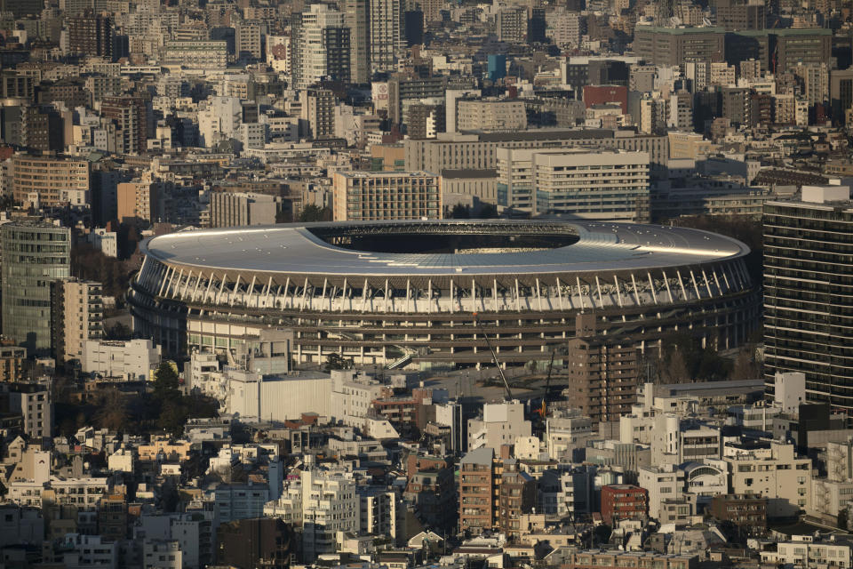 FILE - In this Monday, Jan. 20, 2020, file photo, New National Stadium, a venue for the opening and closing ceremonies at the Tokyo 2020 Olympics, is seen from Shibuya Sky observation deck in Tokyo. The Tokyo Olympics open exactly six months from Friday, Jan. 24, 2020 and the United States and China are picked to finish 1-2 in the overall medal count and the gold-medal count. That's the easy part in a forecast done by Gracenote Sports about which countries will win the most Olympic medals. Gracenote supplies analysis for leagues around the world and has a solid track record forecasting recent Olympics. (AP Photo/Jae C. Hong, File)