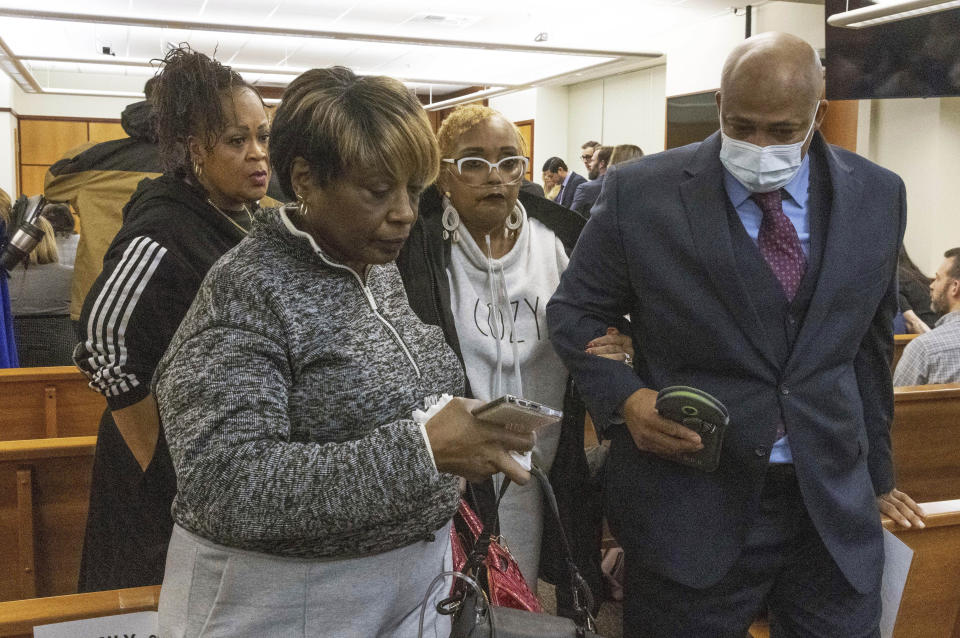 Manny Ellis's mother, Marcia Carter-Patterson, second from right, is escorted out of court by family attorney James Bible, right, and other family members after Pierce County Judge Bryan Chushcoff reads the verdict from the jury for the killing of Manny Ellis in Pierce County Superior Court Thursday, Dec. 21, 2023 in Tacoma, Wash. A jury cleared three Washington state police officers of all criminal charges Thursday in the 2020 death of Manuel Ellis, a Black man who was shocked, beaten and restrained face down on a Tacoma sidewalk as he pleaded for breath. (Ellen M. Banner/The Seattle Times via AP, Pool)