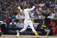 San Diego Padres' Fernando Tatis Jr. watches his solo home run off Cincinnati Reds starting pitcher Wade Miley during the sixth inning of a baseball game Thursday, June 17, 2021, in San Diego. (AP Photo/Derrick Tuskan)