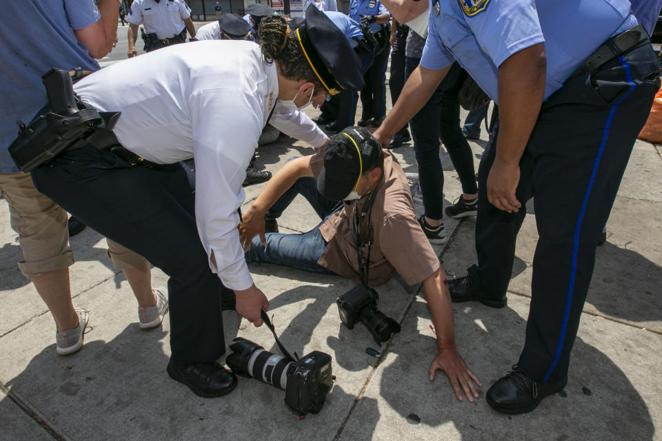 Police Commissioner and Mayor. Police Commissioner Danielle Outlaw, left, and other officers attend to Associated Press photographer Matt Rourke after he was assaulted while touring the business district at N. Broad Street and Erie Avenue in Philadelphia on Thursday, June 4, 2020. (Alejandro A. Alvarez/The Philadelphia Inquirer via AP)