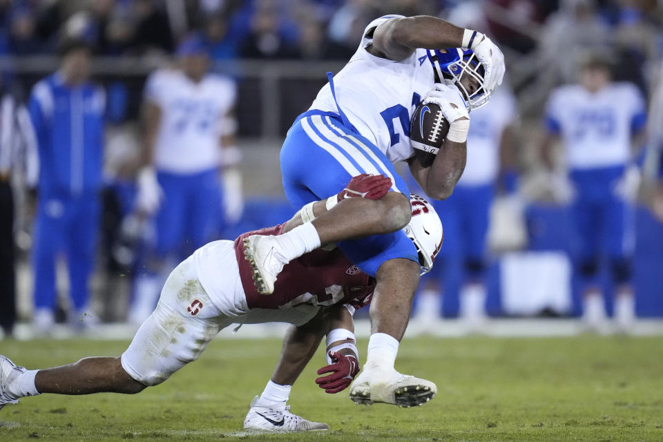 Stanford safety Jonathan McGill (2) tackles BYU running back Christopher Brooks (2) during the second half of an NCAA college football game in Stanford, Calif., Saturday, Nov. 26, 2022. (AP Photo/Godofredo A. Vásquez)