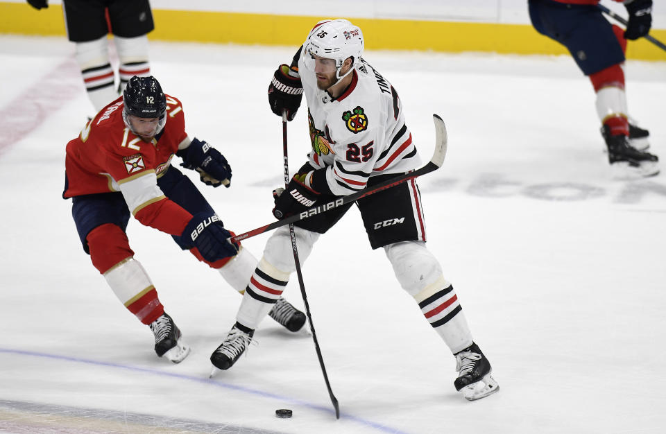 Florida Panthers center Eric Staal (12) tries to stop Chicago Blackhawks defenseman Jarred Tinordi (25) during the first period of an NHL hockey game, Friday, March 10, 2023, in Sunrise, Fla. (AP Photo/Michael Laughlin)