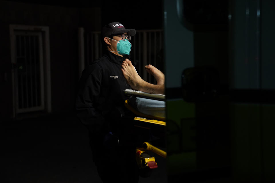 Emergency medical technician Thomas Hoang, 29, of Emergency Ambulance Service, loads a patient into an ambulance in Placentia, Calif., Friday, Jan. 8, 2021. EMTs and paramedics have always dealt with life and death — they make split-second decisions about patient care, which hospital to race to, the best and fastest way to save someone — and now they're just a breath away from becoming the patient themselves. (AP Photo/Jae C. Hong)