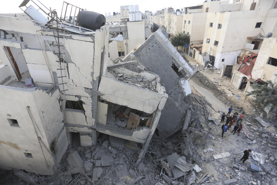 Palestinians look at destruction by the Israeli bombardment of the Gaza Strip in Rafah on Wednesday, Nov. 22, 2023. (AP Photo/Hatem Ali)
