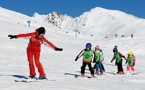 ESF leader with a line of children skiing in Passo Tonale
