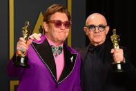 Singer-songwriter Elton John and lyricist Bernie Taupin pose in the press room with the Oscar for Best Original Song for "(I'm Gonna) Love Me Again" from the movie "Rocketman" during the 92nd Oscars at the Dolby Theater in Hollywood, California on February 9, 2020. (Photo by FREDERIC J. BROWN/AFP via Getty Images)
