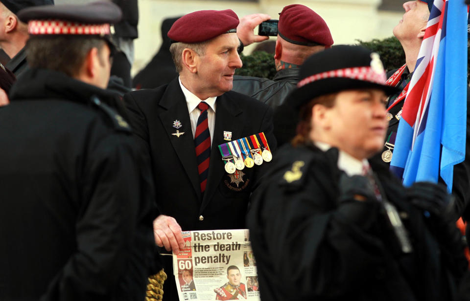 Police and servicemen gather outside the Old Bailey in London, Wednesday Feb. 26, 2014, ahead of the sentencing of Michael Adebolajo and Michael Adebowale who were convicted of murdering 25-year-old fusilier Lee Rigby. Adebolajo, an al-Qaida-inspired extremist, was sentenced to life without parole Wednesday for hacking a British soldier to death on a London street in front of horrified passers-by. The self-described "soldier of Allah" was sentenced at Central Criminal Court along with his accomplice, 22-year-old Michael Adebowale, who received a minimum 45-year sentence. (AP Photo/PA, Sean Dempsey) UNITED KINGDOM OUT NO SALES NO ARCHIVE