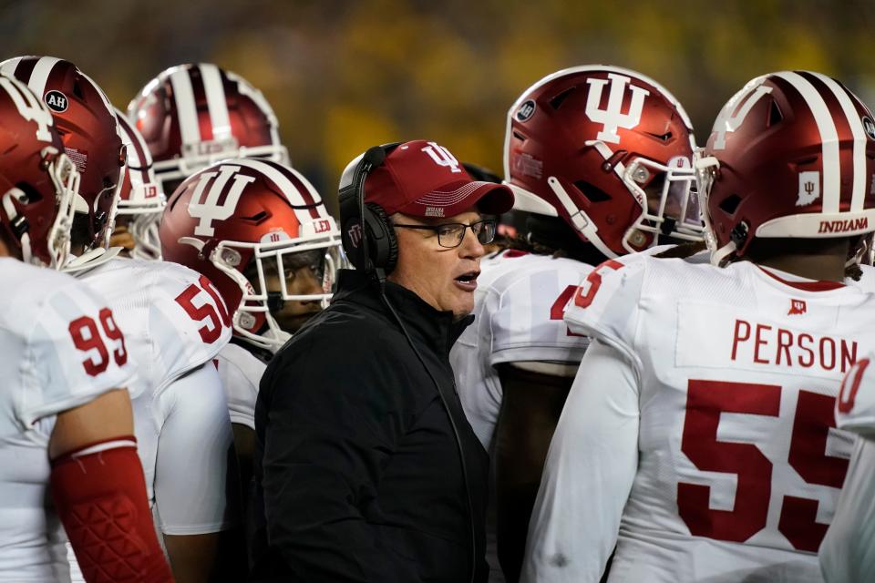 Indiana head coach Tom Allen stands next to his team during the first half of an NCAA college football game against Michigan, Saturday, Nov. 6, 2021, in Ann Arbor, Mich. (AP Photo/Carlos Osorio)