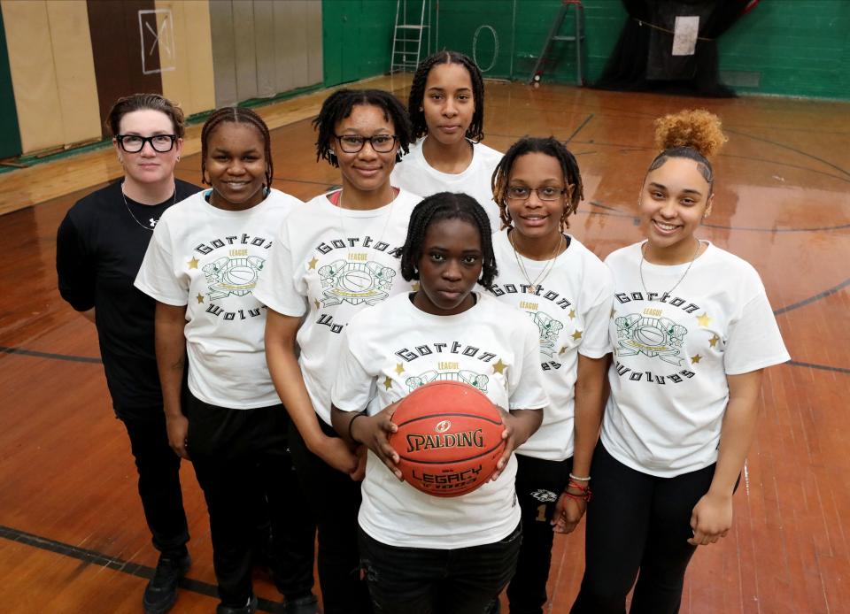 Gorton High School girls basketball players are pictured in a basement gymnasium at the school in Yonkers, Feb. 9, 2024. They are from left: coach Dawn Myers, Dy'Shalah Johnson, captain Asia Kirkpatrick, captain Sanaa Lee, Janai Wilcox (front), Nychel Prioleau and Miayah Escobar.