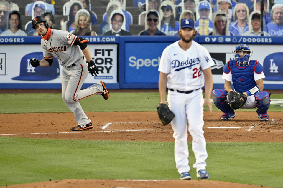 San Francisco Giants' Austin Slater, left, runs to first base as he hits a solo home run while Los Angeles Dodgers starting pitcher Clayton Kershaw, center, and catcher Austin Barnes, right, watch during the third inning of a baseball game Saturday, Aug. 8, 2020, in Los Angeles. (AP Photo/Mark J. Terrill)