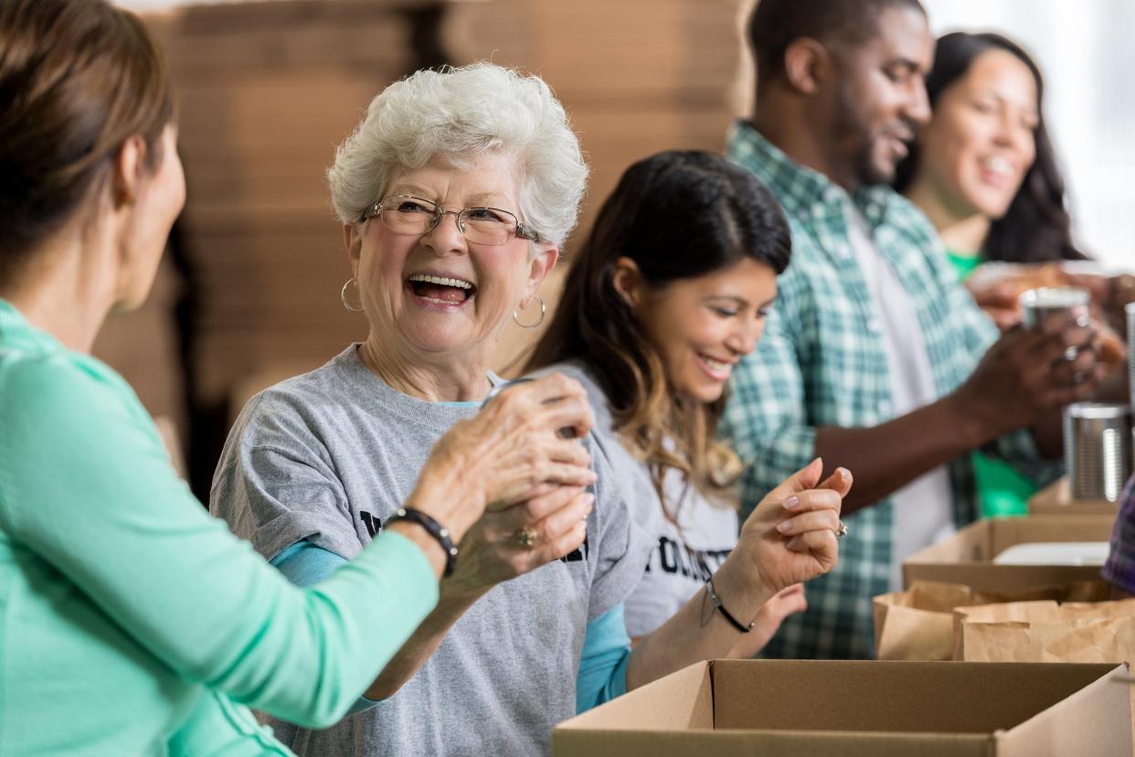 cheerful senior woman volunteers at food bank