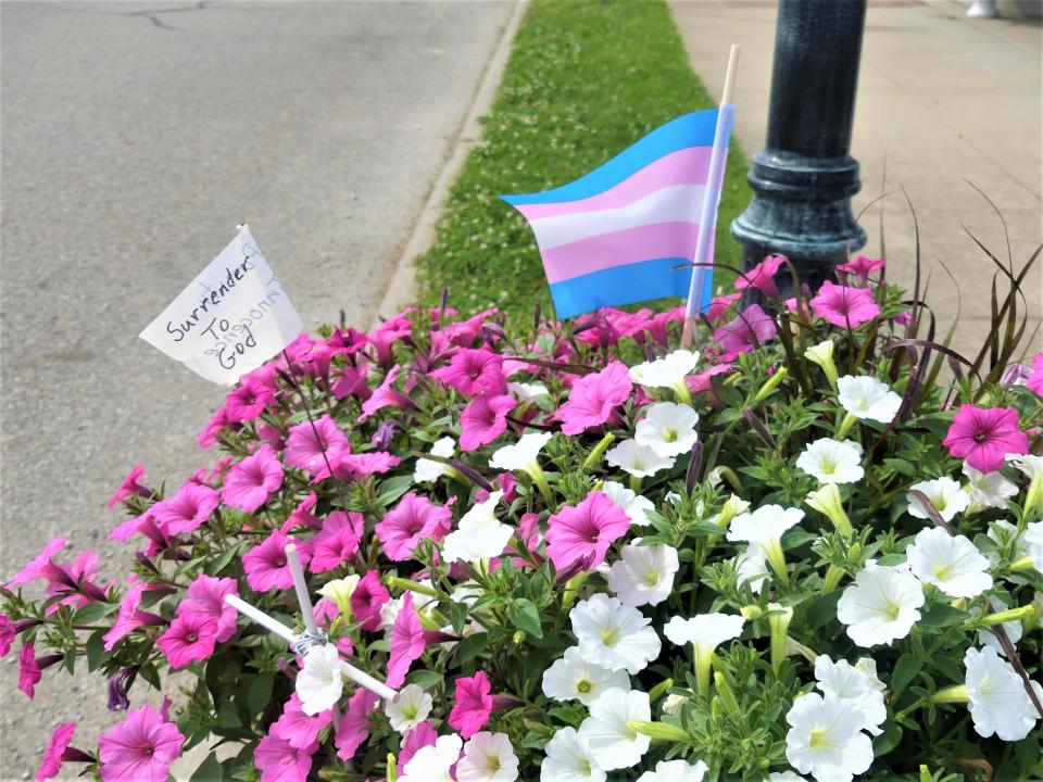 An LGBTQ+ Pride flag flies alongside a handmade Christian flag in a Loogootee flower pot. City officials moved to take both flags out following public outcry.
