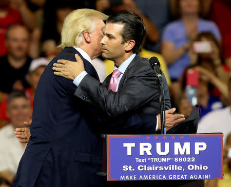 Donald Trump hugs his son Donald Trump Jr. at a campaign rally in St. Clairsville, Ohio June 28, 2016. REUTERS/Aaron Josefczyk
