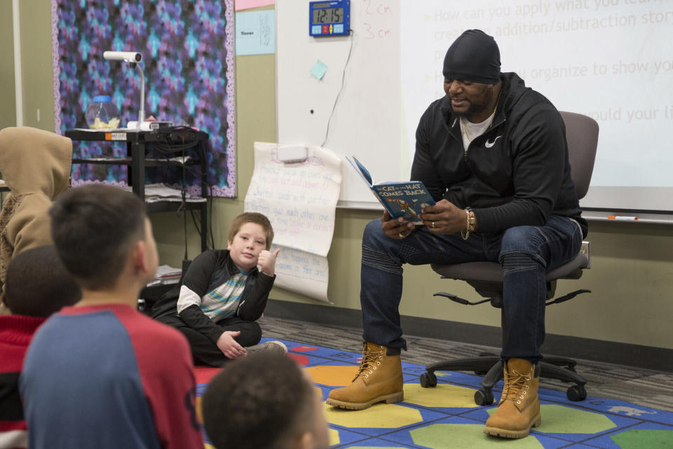 In this image provided by the Des Moines Public Schools, Will Keeps reads a Dr. Seuss story to students at Lovejoy Elementary School in Des Moines, Iowa, during their "VIPs Read to Students" event on March 2, 2020. Keeps is hospitalized in serious condition after surgery following just the sort of violence he's devoted his life to stop -- a shooting that killed two teenagers at the Starts Right Here educational program he founded in Des Moines. Keeps was hurt Monday, Jan. 23, 2023, when he tried to intervene. (Kyle Knicley/Des Moines Public Schools via AP)