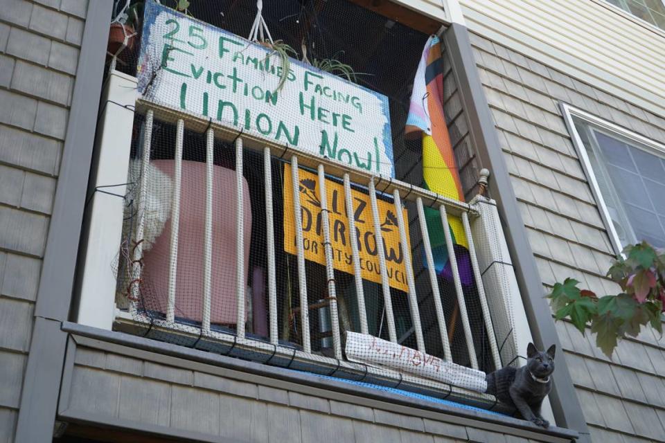 A painted sign that says ’25 families facing eviction here. Union now!’ hangs on the balcony of a residence at the Meadow Wood Townhomes on Sept. 22, in Bellingham, Washington. Rachel Showalter/The Bellingham Herald