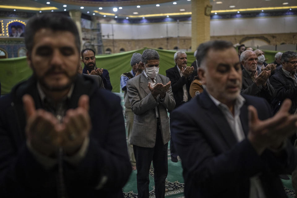 Iranian men are praying with or without a protective face mask in a mosque in Arak, capital of Markazi Province | Sina Yaghoobpoor—Middle East Images/Redux