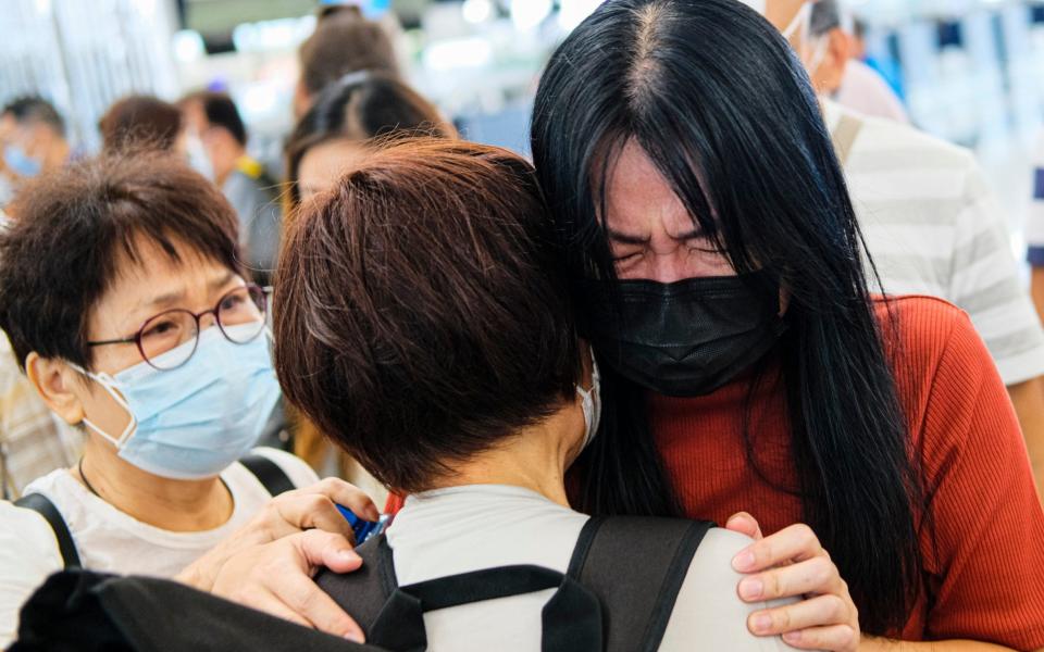 People say goodbye to each other at Hong Kong airport - Sawayasu Tsuji /Getty Images AsiaPac 