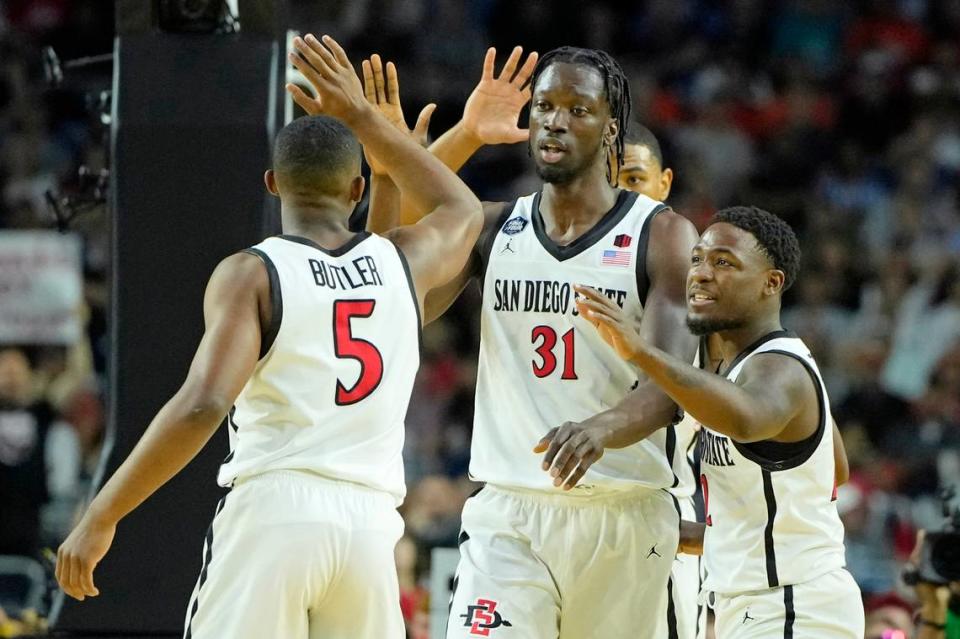 San Diego State Aztecs forward Nathan Mensah (31) high fives guard Lamont Butler (5) after a play against the Florida Atlantic Owls in the semifinals of the Final Four of the 2023 NCAA Tournament at NRG Stadium.