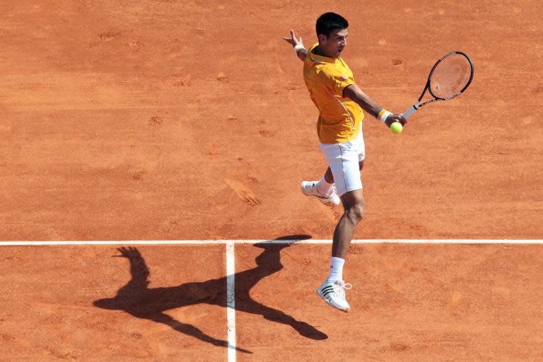 Serbian Novak Djokovic hits a return to Spanish Albert Ramos-Vinolas during the Monte-Carlo ATP Masters Series Tournament tennis match, on April 14, 2015 in Monaco