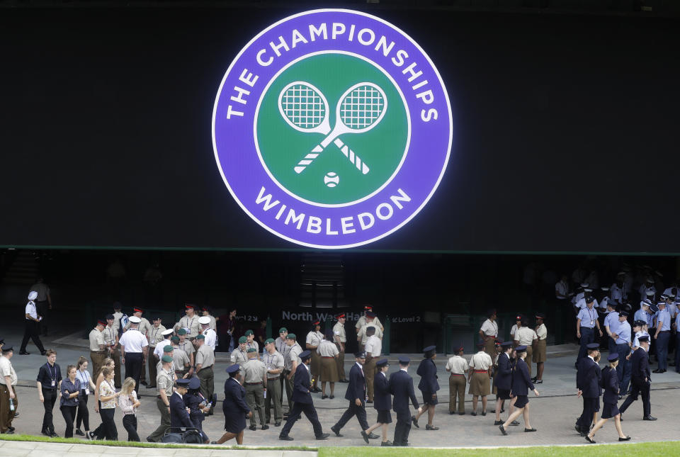 FILE - Stewards prepare for the start of the Wimbledon Tennis Championships in London, Sunday, June 30, 2019. This year's Wimbledon tournament begins on Monday, July 1.(AP Photo/Kirsty Wigglesworth, File)