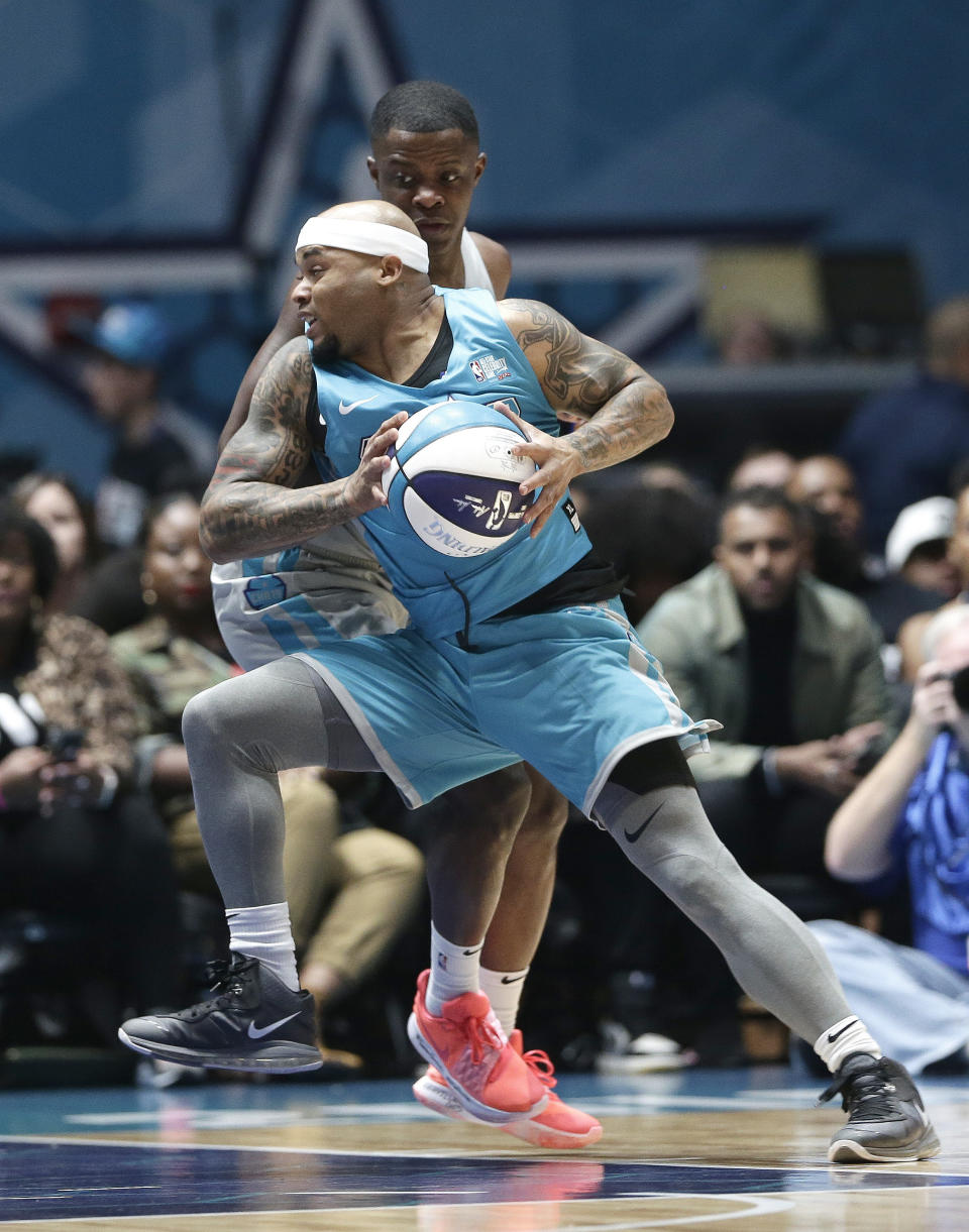 Home team's Steve Smith, front, is pressured by Away team's James Shaw Jr., rear, during the first half of an NBA All-Star Celebrity basketball game in Charlotte, N.C., Friday, Feb. 15, 2019. (AP Photo/Gerry Broome)