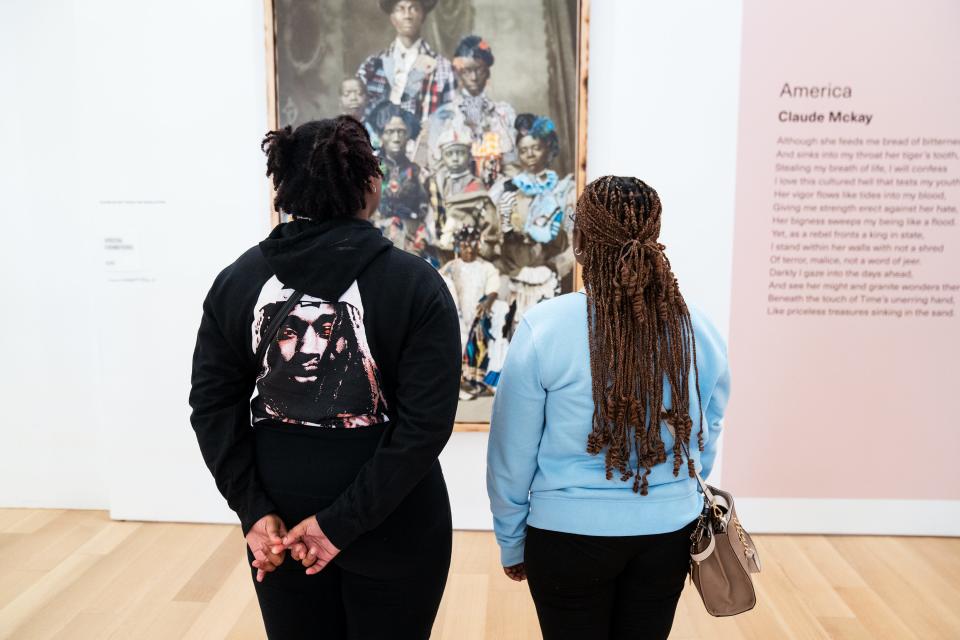 Heaven Campbell, left, and Karissa Pelichet look at “Baker” by artist Stan Squirewell at the International African American Museum in Charleston, S.C. on Jan. 23, 2024.