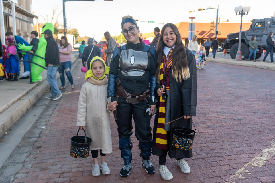 A costumed family enjoy their time Friday at the Halloween Spooktacular on the Square in downtown Canyon.