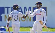 Sri Lankan batsman Dhananjaya de Silva, right, congratulates teammate Pathum Nissanka for scoring a half century against West Indies during the fourth day of their second test cricket match in Galle, Sri Lanka, Thursday, Dec. 2, 2021. (AP Photo/Eranga Jayawardena)