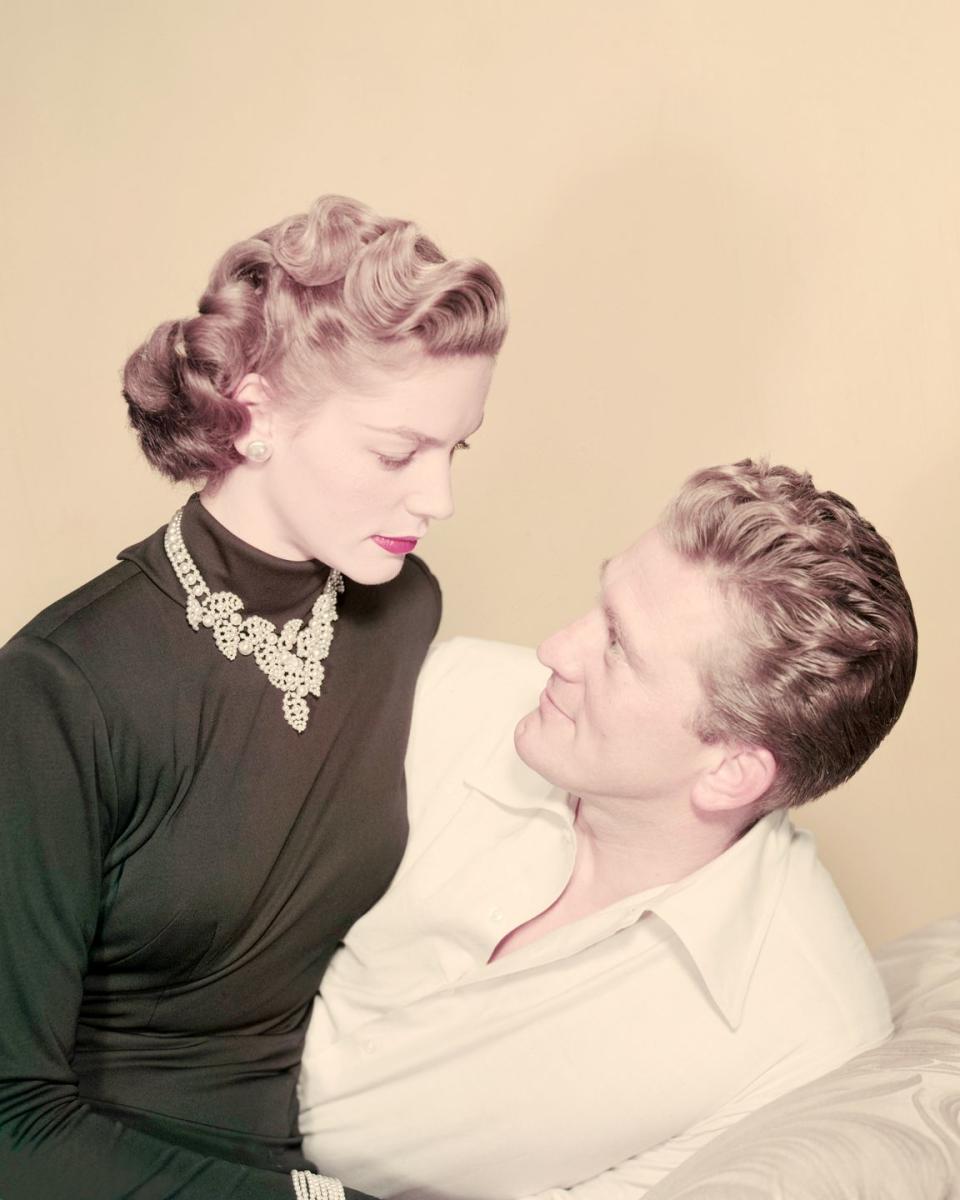 <p>Douglas poses with his costar Lauren Bacall in a promotional portrait for <em>Young Man With a Horn</em>. </p>