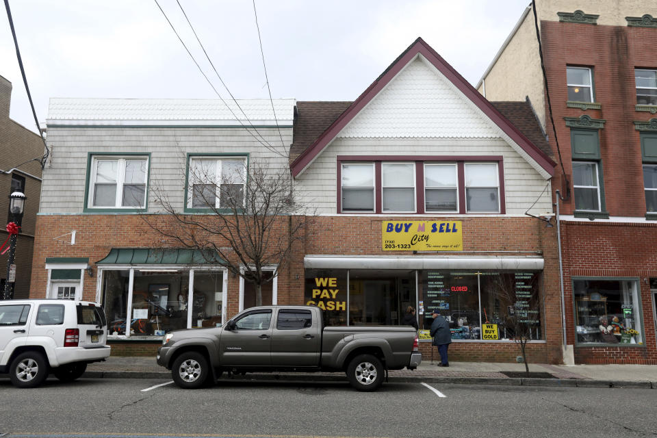 This Sunday, Dec. 15, 2019 photo shows the family-owned Buy n Sell pawn shop searched by the FBI over the weekend in Keyport, N.J. A New Jersey man whose number was found in the back pocket of one of the perpetrators of last week's fatal attack on a Jewish market has been arrested for illegally possessing a weapon. The number belonged to Ahmed A-Hady, and the address was for a storefront for the pawnshop. (Ed Murray/NJ Advance Media via AP)