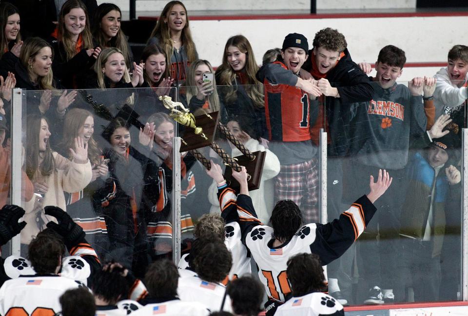 Marlborough fans react to the team bringing over the trophy after their win over Hopkinton in the Daily News Cup hockey championships at the New England Sports Center in Marlborough.