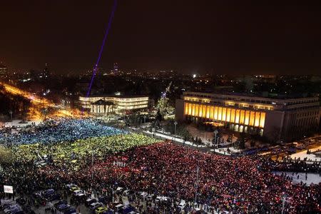 Protesters display the Romanian national flag colours during a demonstration in front of the government building in Bucharest, Romania, February 12, 2017. Inquam Photos/Liviu Florin Albei via REUTERS