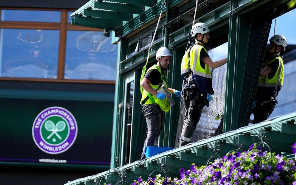 Window cleaners work around the course ahead of day eight of the 2022 Wimbledon Championships at the All England Lawn Tennis and Croquet Club, Wimbledon. Picture date: Monday July 4, 2022 - Zac Goodwin/PA