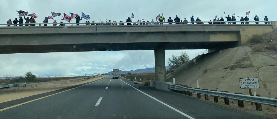 Supporters line up on an overpass in the Barstow area on Wednesday, Feb. 23 to cheer on the cross-country People’s Convoy toward Washington, D.C.