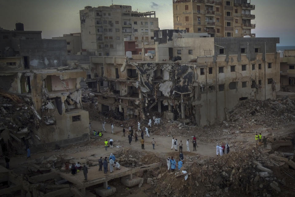 People search for flood victims in Derna, Libya, Friday, Sept. 15, 2023. Search teams are combing streets, wrecked buildings, and even the sea to look for bodies in Derna, where the collapse of two dams unleashed a massive flash flood that killed thousands of people. (AP Photo/Ricardo Garcia Vilanova)