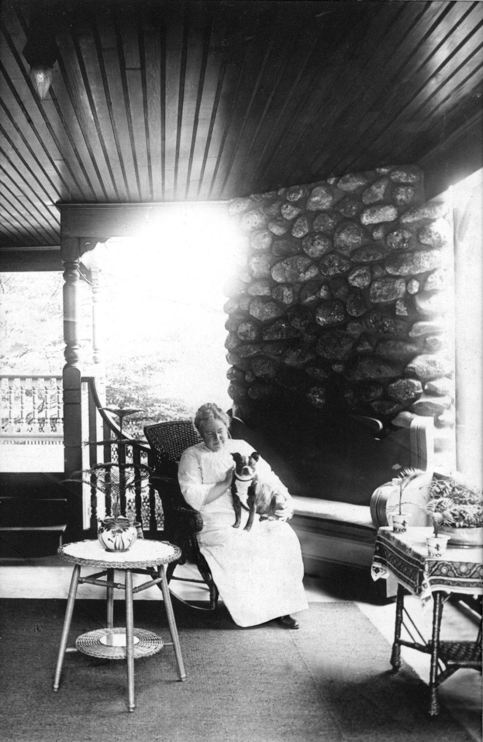 Lizzie Borden on the piazza of her Fall River residence, Maplecroft, holding her beloved Boston terrier, Laddie Miller Borden, circa 1916.