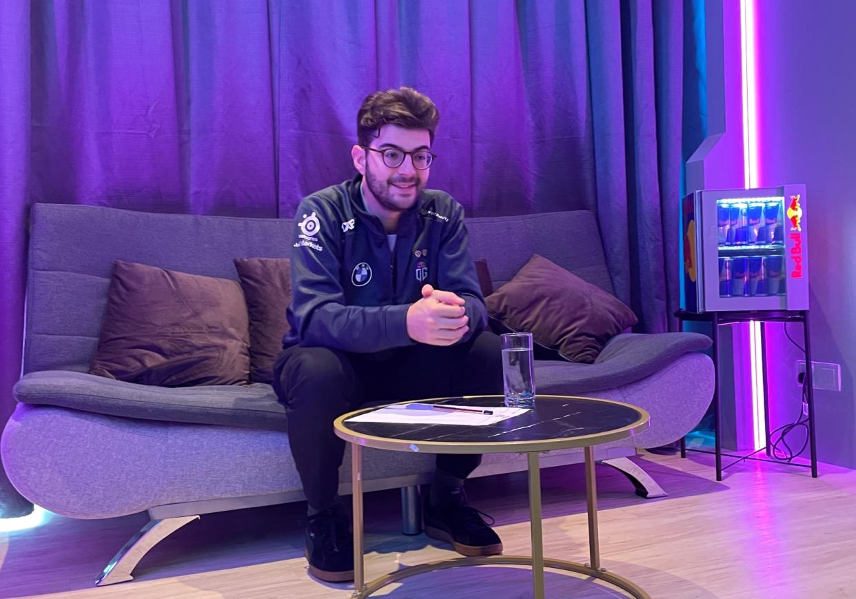 Ceb seated on a sofa wearing a jacket with neon lighting