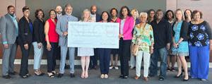 Holding check L to R: Thomas Parrish-SECU Foundation Board Member; Jama Campbell-SECU Foundation Executive Director; Tiffany Jones-UNCF Area Development Director; and Natia Walker-UNCF Development Director, surrounded by SECU leadership and local Advisory Board members.