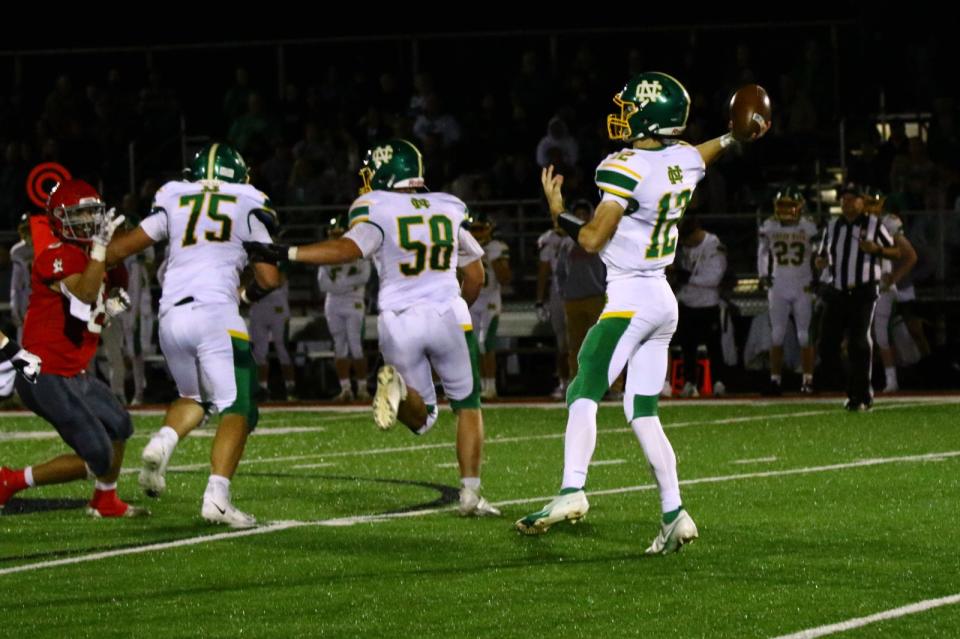 Newark Catholic offensive linemen Connor Wright (75) and Nate Willis (58) provide ample protection for quarterback Miller Hutchison during the 42-14 win at Johnstown.