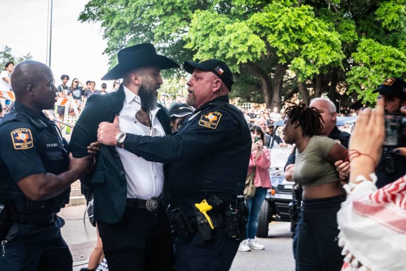 Law enforcement officers confront a protester during a pro-Palestinian protest by the University of Texas Students. Sandra Dahdah/ZUMA Press Wire/dpa