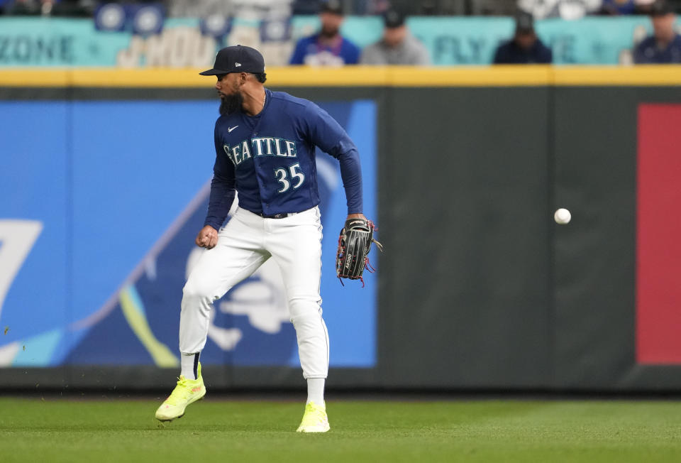 Seattle Mariners right fielder Teoscar Hernandez makes a fielding error on a single from Houston Astros' Alex Bregman, allowing Bregman to reach third base, during the seventh inning of a baseball game Wednesday, Sept. 27, 2023, in Seattle. (AP Photo/Lindsey Wasson)